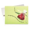 "Shower You with Love" Christmas Card features an organza bag filled with red metallic hearts. Front message invites you to "open bag & toss contents into the air"